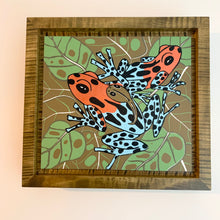 Load image into Gallery viewer, Dart frog woodcut framed in olive green solid tiger maple wood
