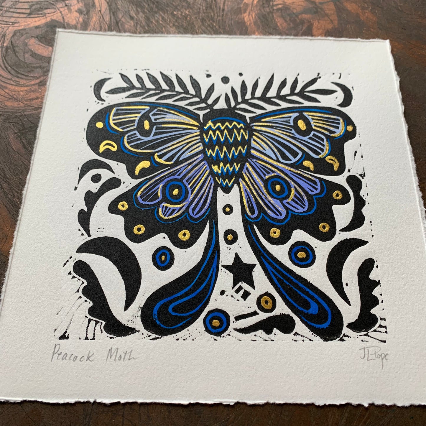 Handpainted blue moth linocut