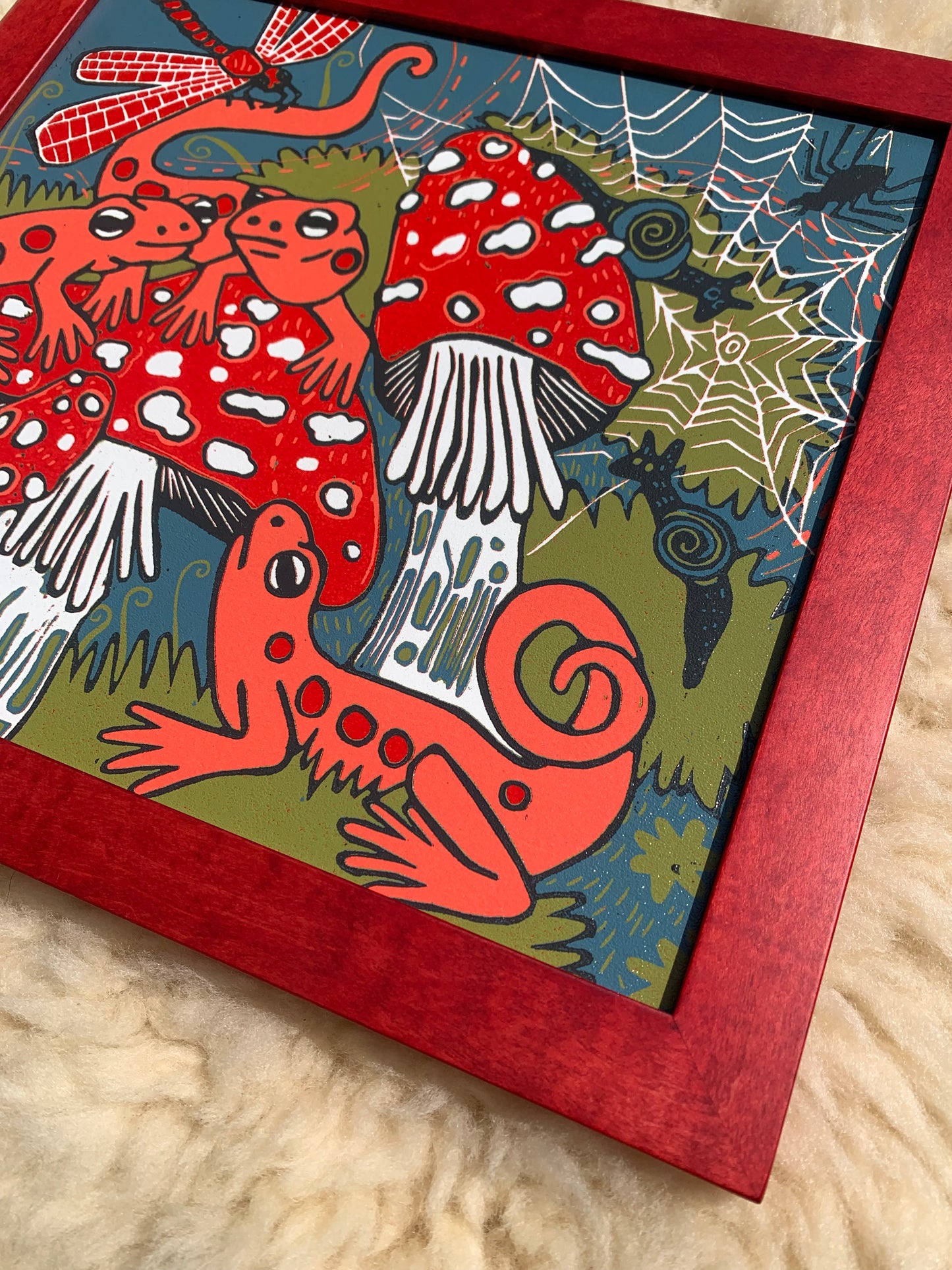 Red eft and mushroom framed in red