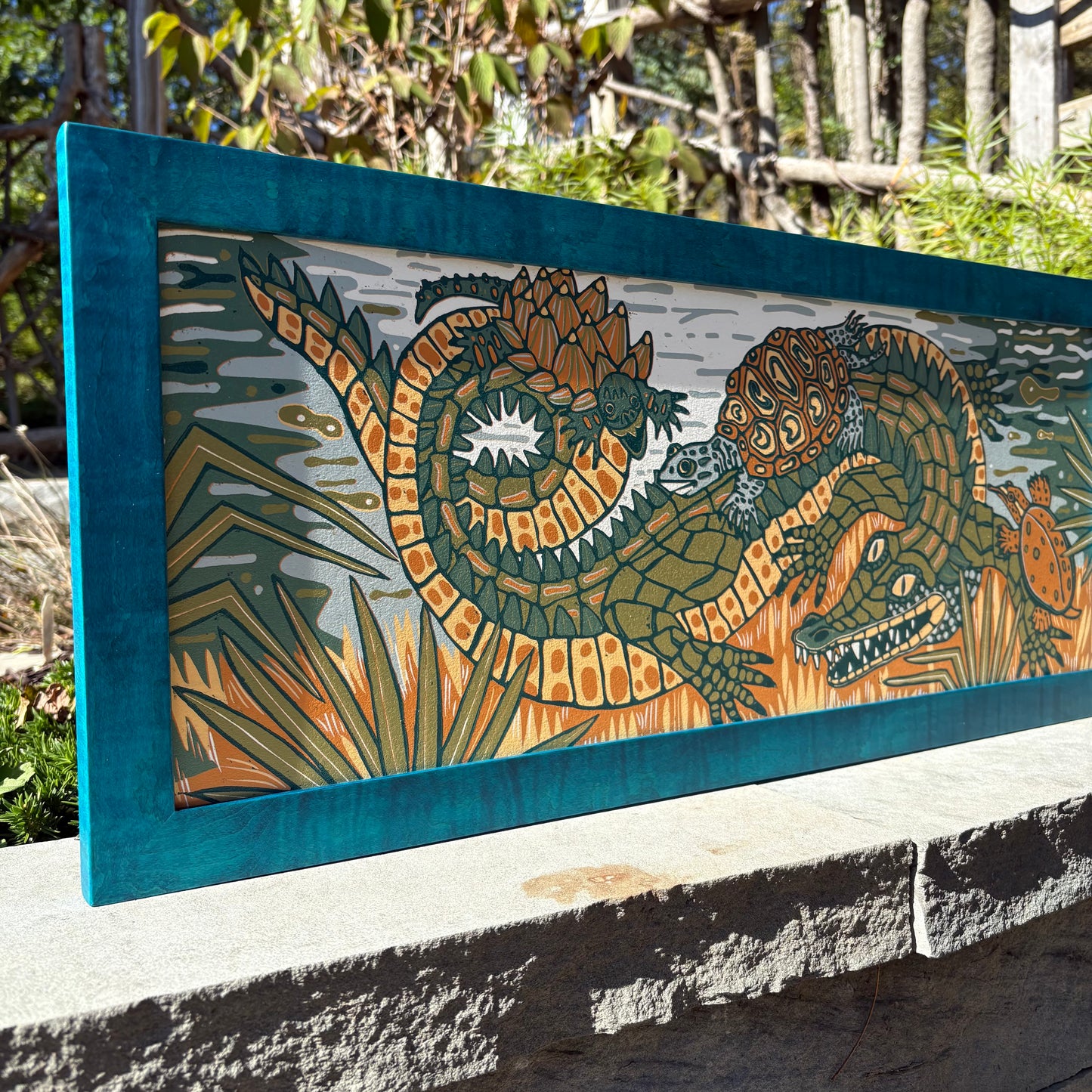 Gator and turtle woodcut framed in turquoise