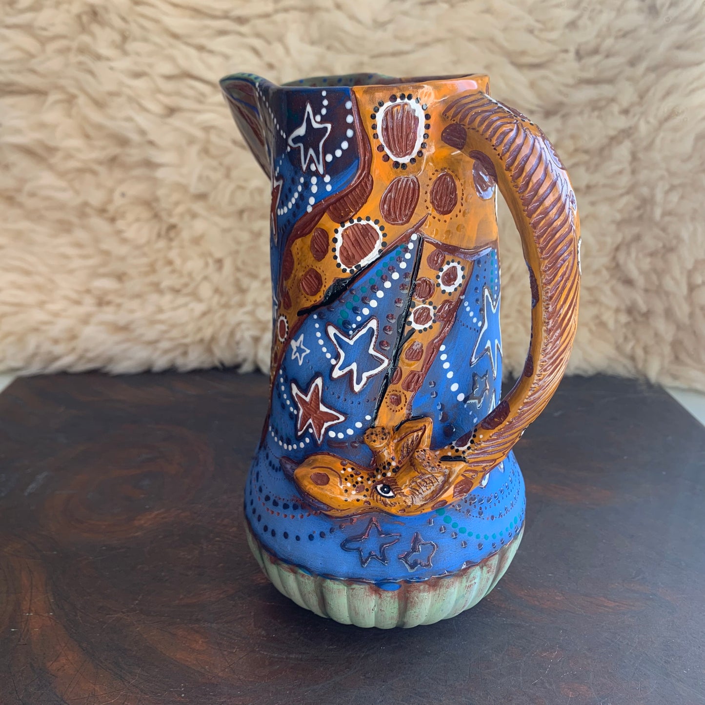 Giraffe pitcher with blue starry sky