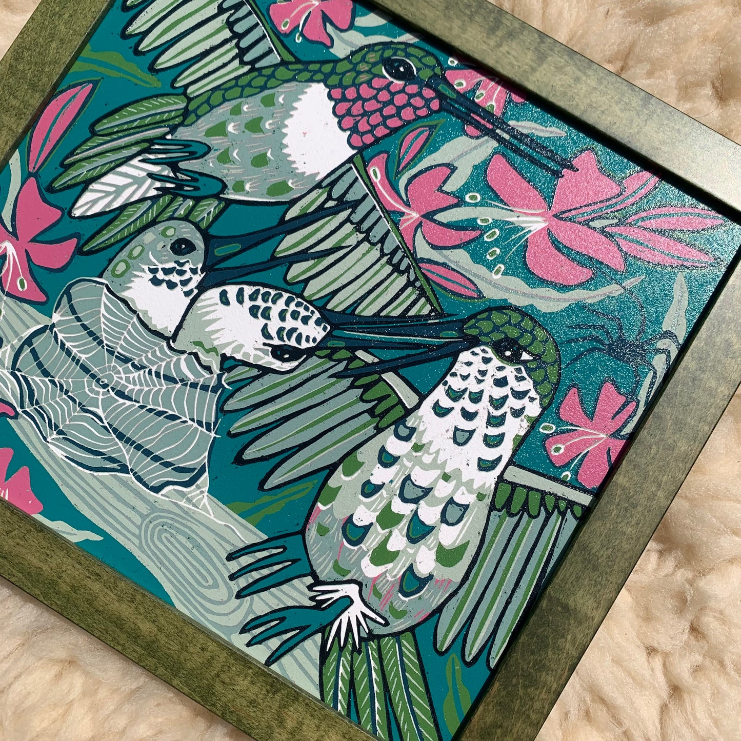 Hummingbird and spiderweb framed in green