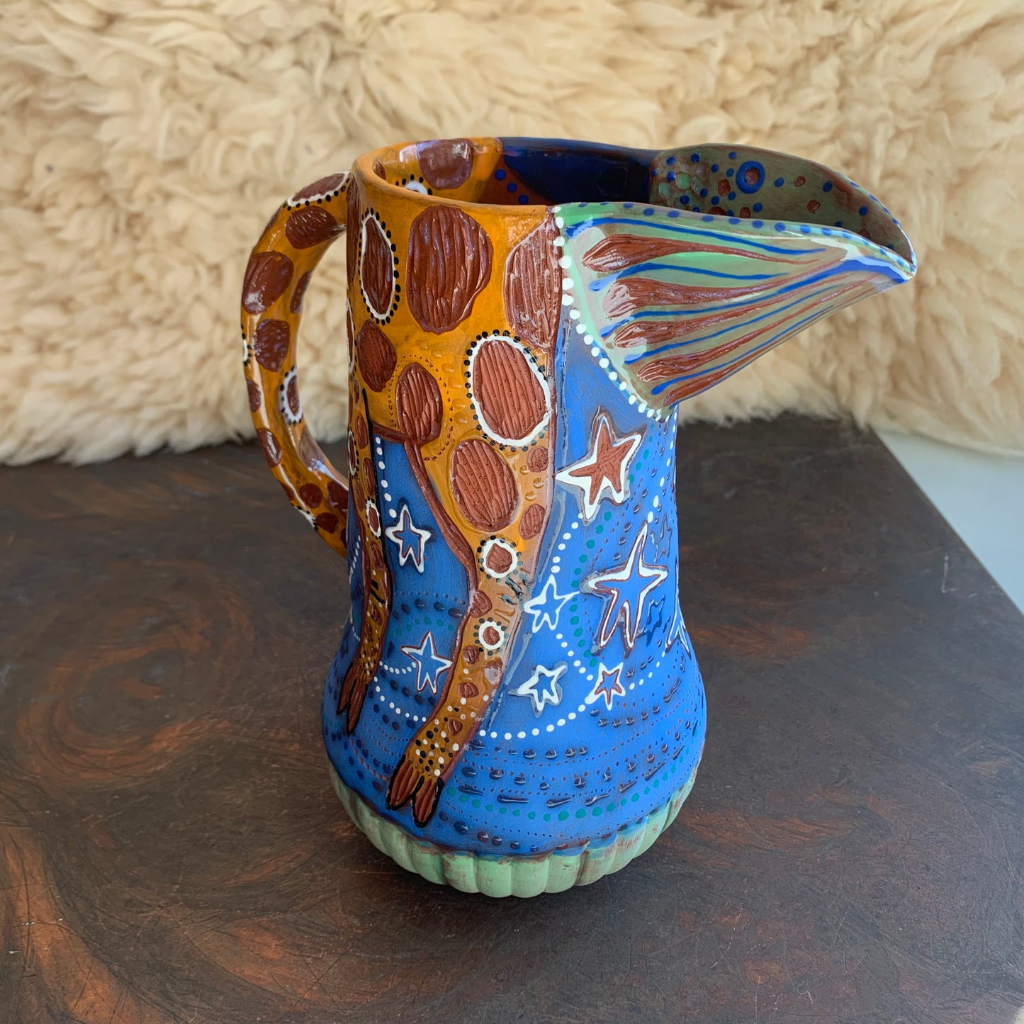 Giraffe pitcher with blue starry sky
