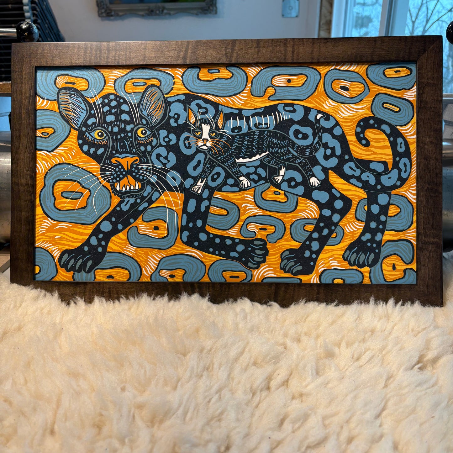 Jaguar and housecat framed in black