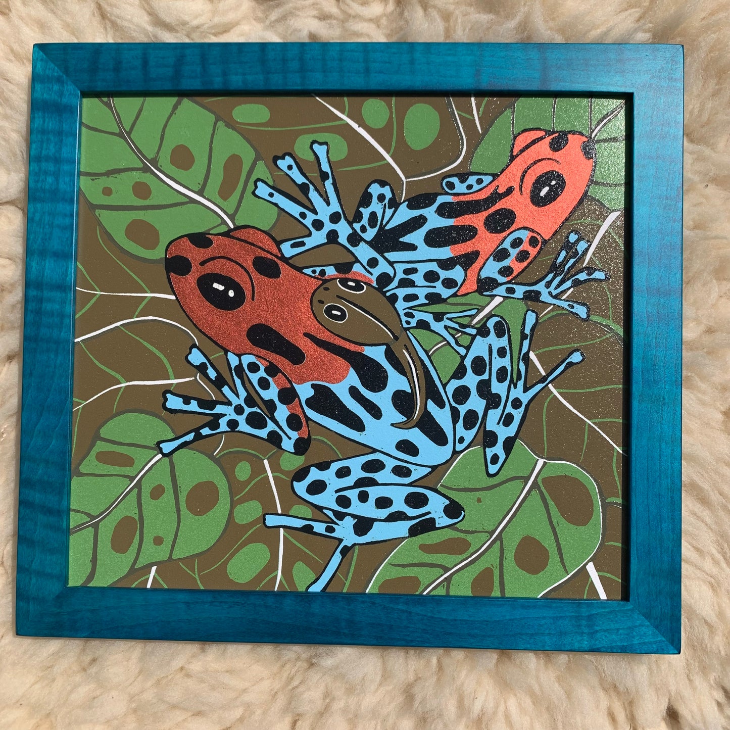 Dart frog woodcut framed in solid tiger maple wood