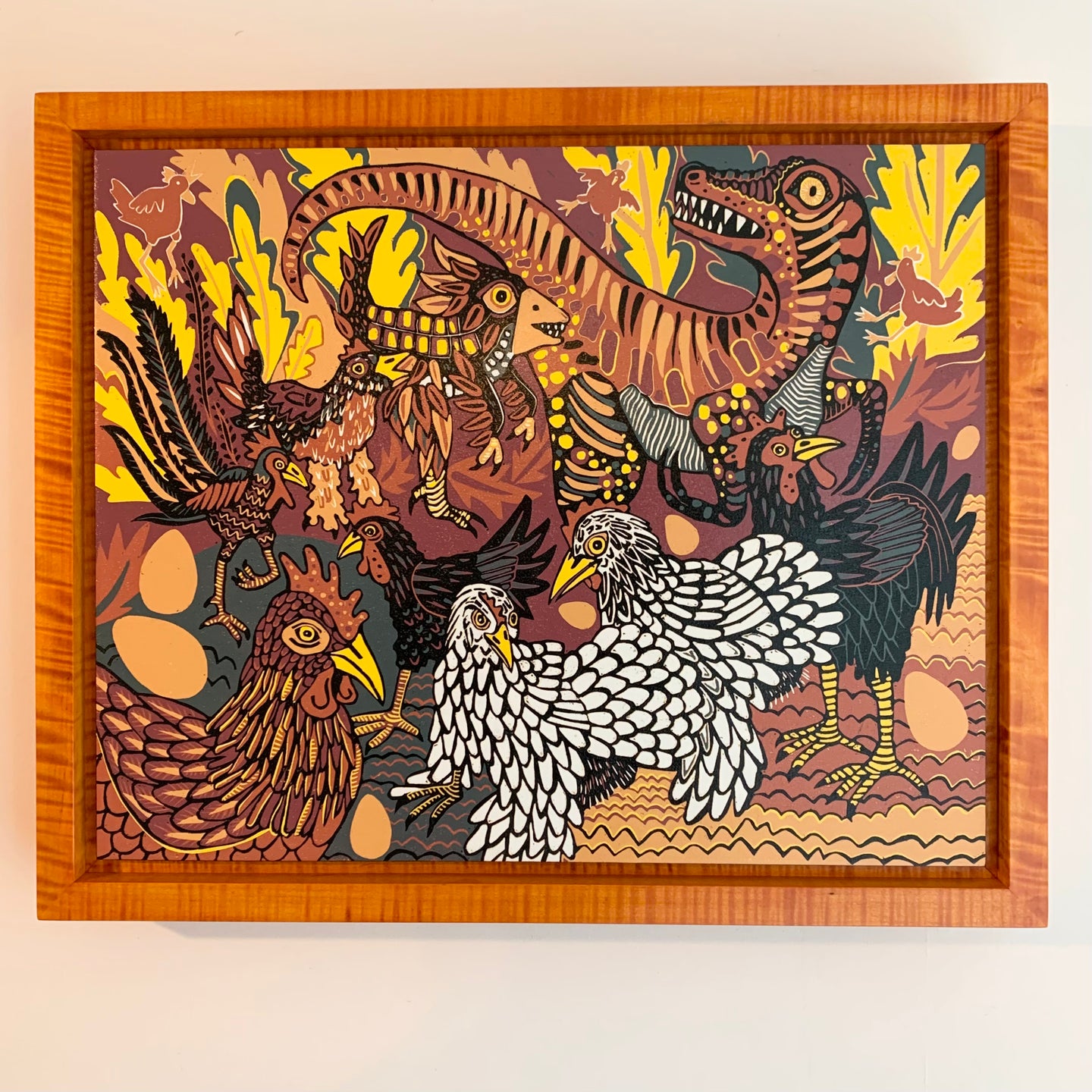 Evolution of chickens woodcut framed in orange curly maple