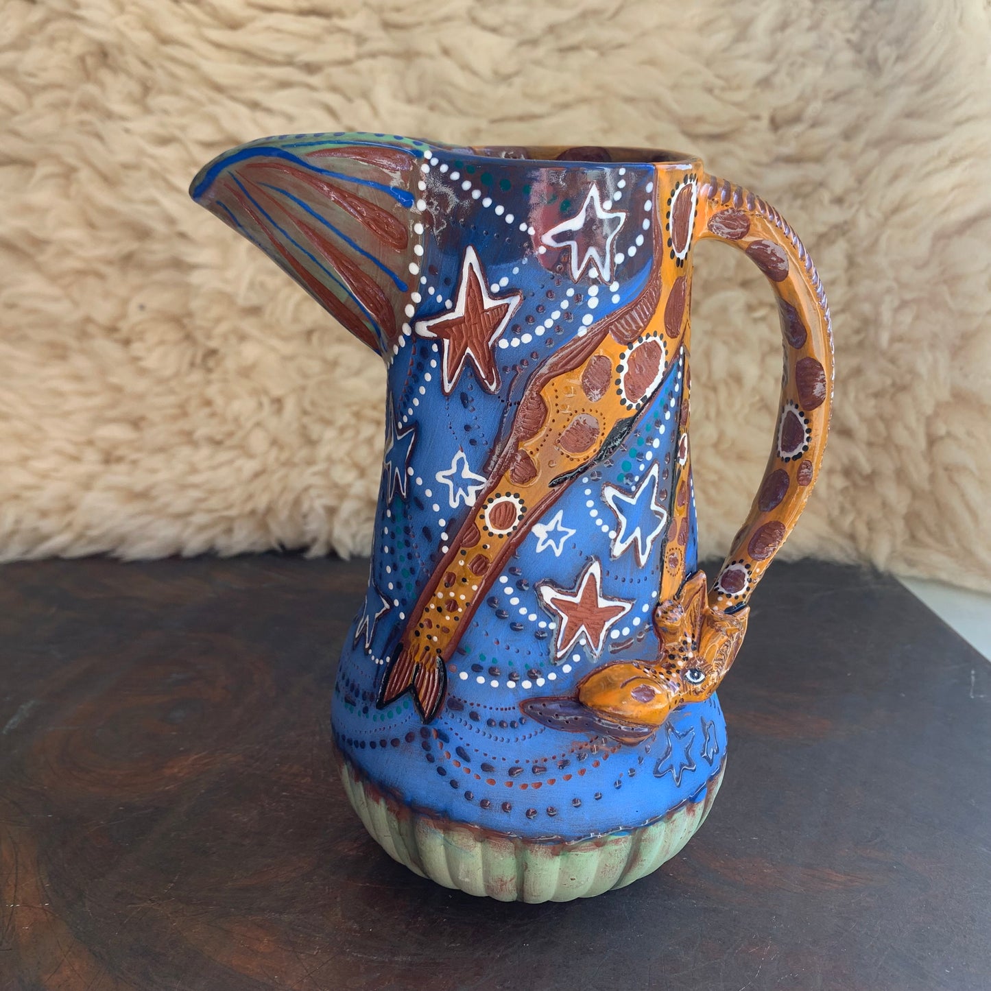 Giraffe pitcher with blue starry sky