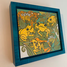 Load image into Gallery viewer, Dart frog woodcut framed in blue solid tiger maple wood

