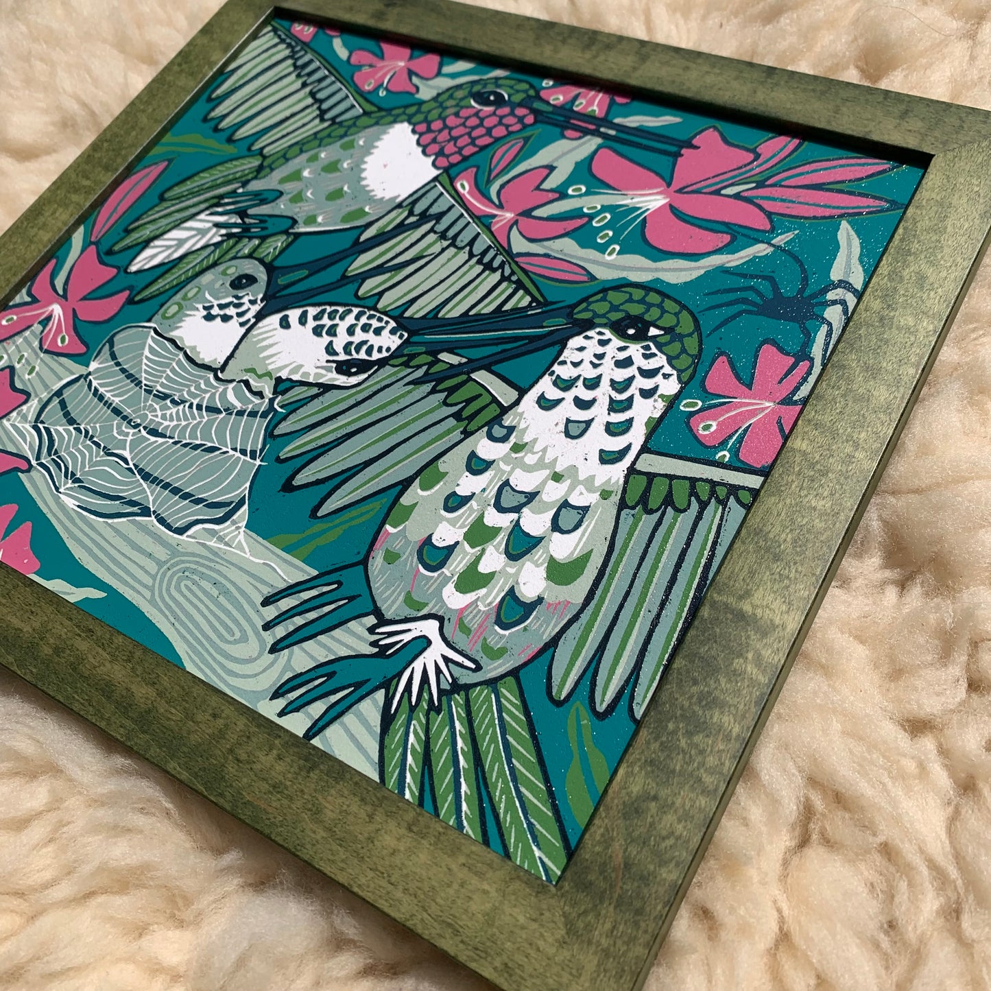 Hummingbird and spiderweb framed in green