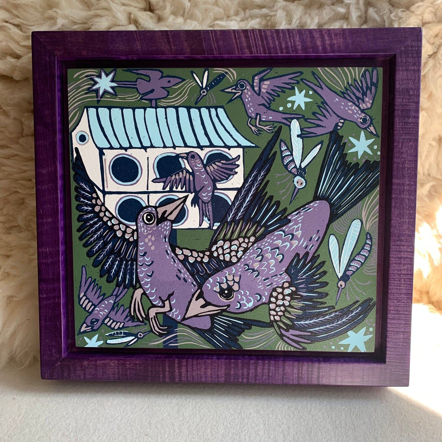 Purple Martin woodcut framed in a purple frame